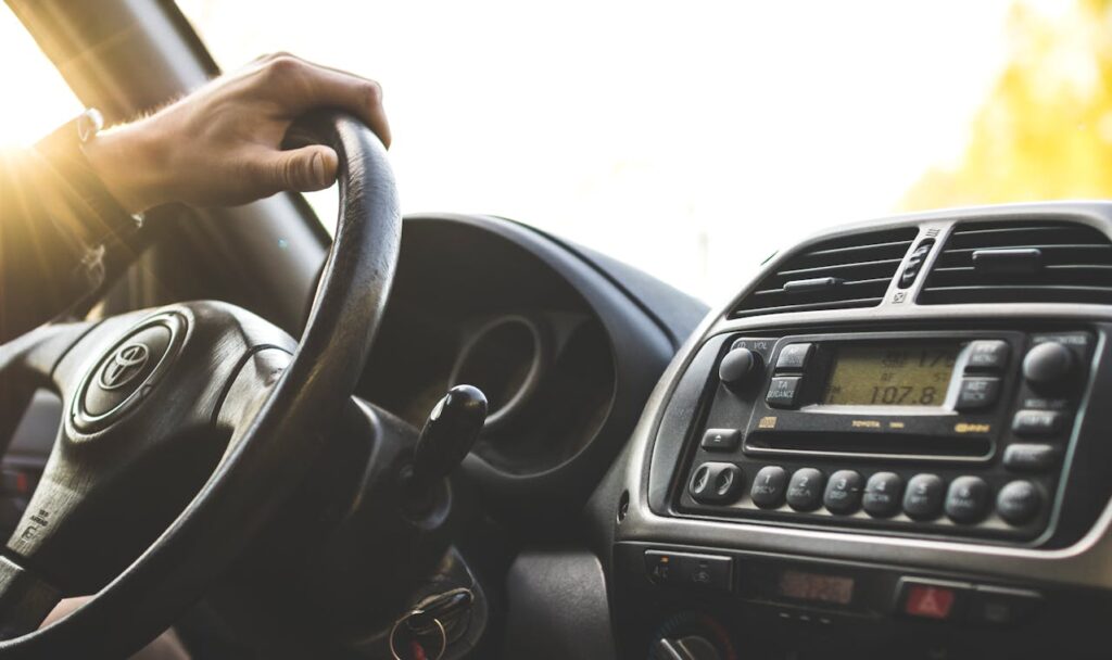 person driving; view of car dashboard