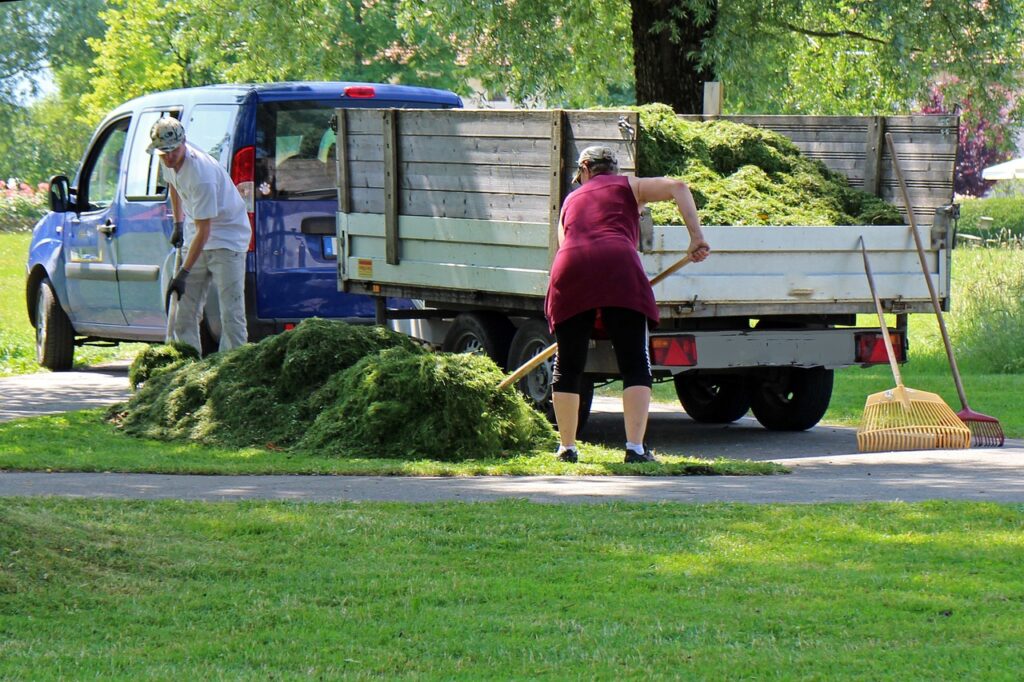 landscape workers raking 